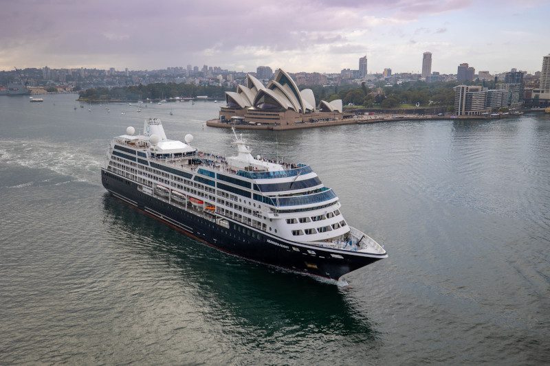 Azamara Quest cruise ship sailing into a vibrant sunset, offering luxury and immersive destination experiences.