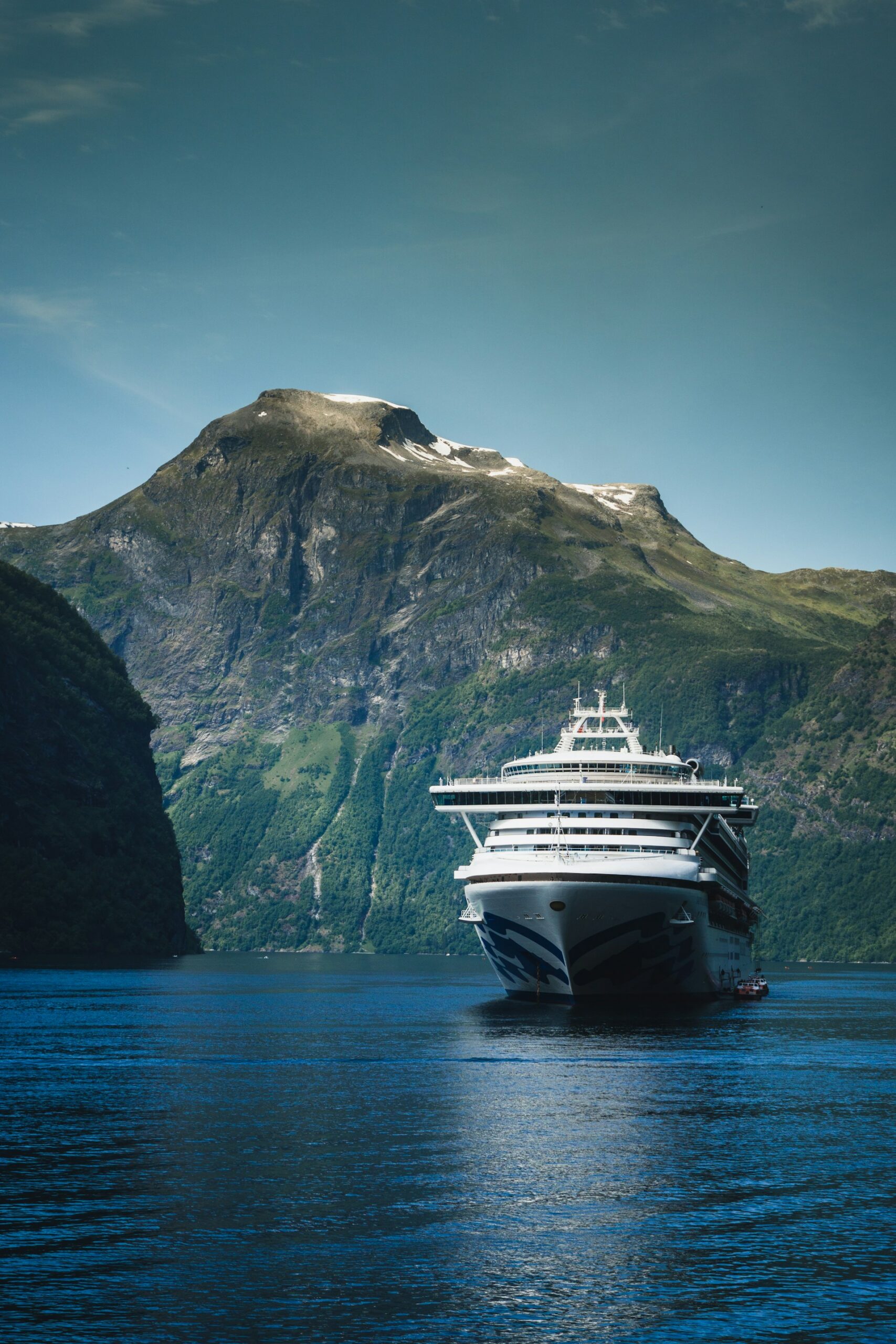 Luxury cruise ship sailing across calm blue water
